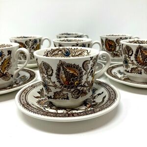 Seven vintage Jacobean Ironstone cups and saucers.